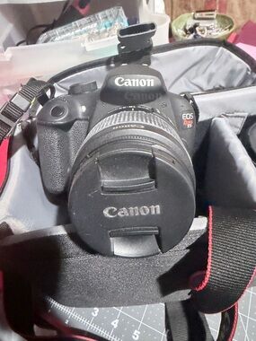 Canon EOS Rebel T5 digital SLR camera with a lens.
